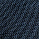 Macro close-up of the Navy Grenadine Tie weave, showing the textured open silk grain.