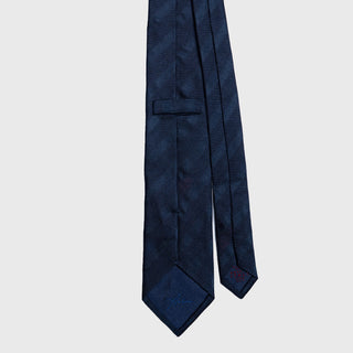 Back view of navy blue grenadine tonal stripe tie with stitched details.