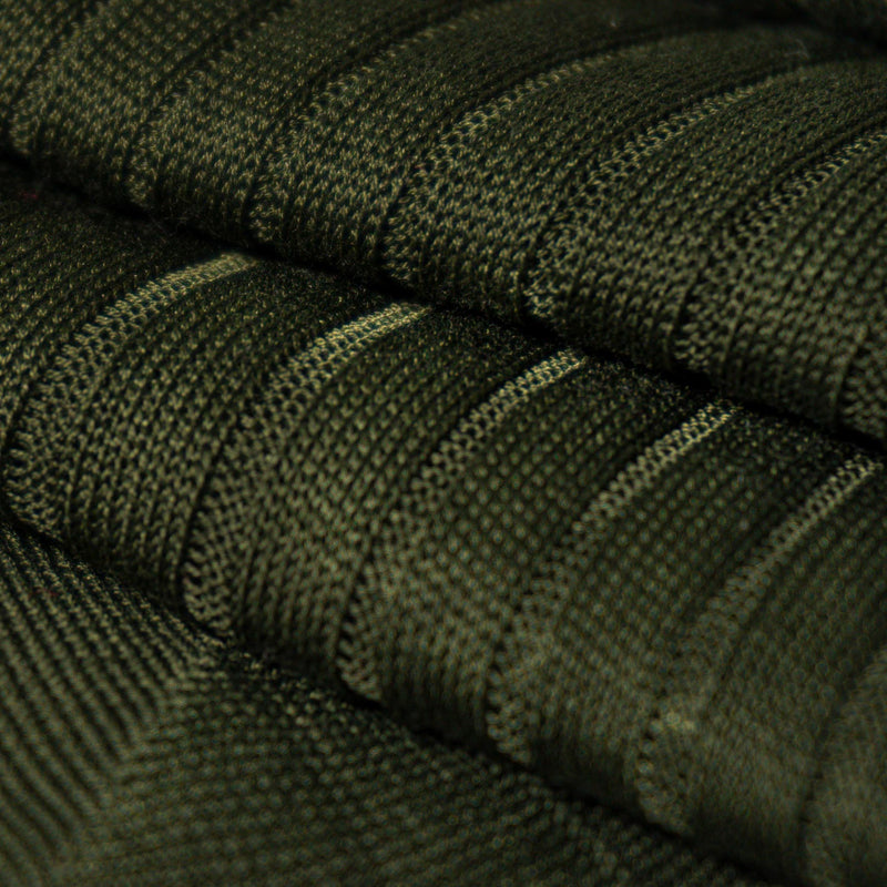 Close-up of olive green ribbed dress sock fabric showcasing premium texture.