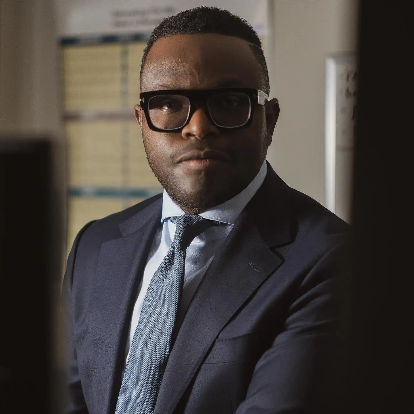 Politician outfits highlight leadership and confidence in a man with suit and glasses