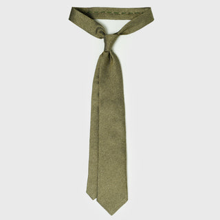 Sage green silk tie displayed untied, showcasing its six-fold craftsmanship.