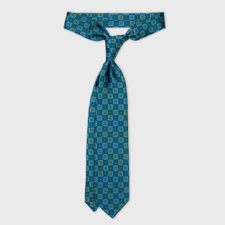 The Marshall teal foulard tie, knotted four-in-hand, by Aklasu.