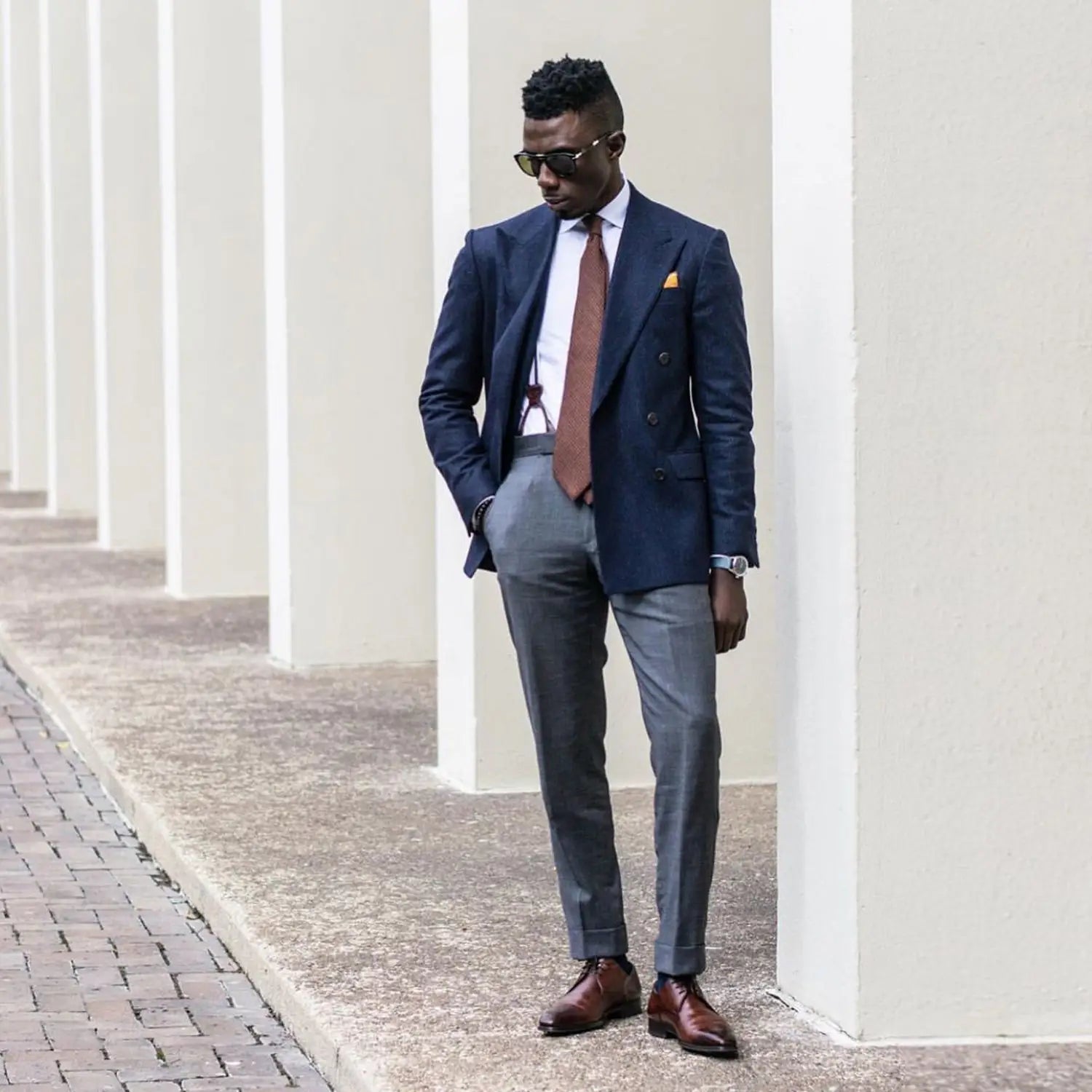 Well-dressed man in a suit demonstrating how to tie correctly for professional success