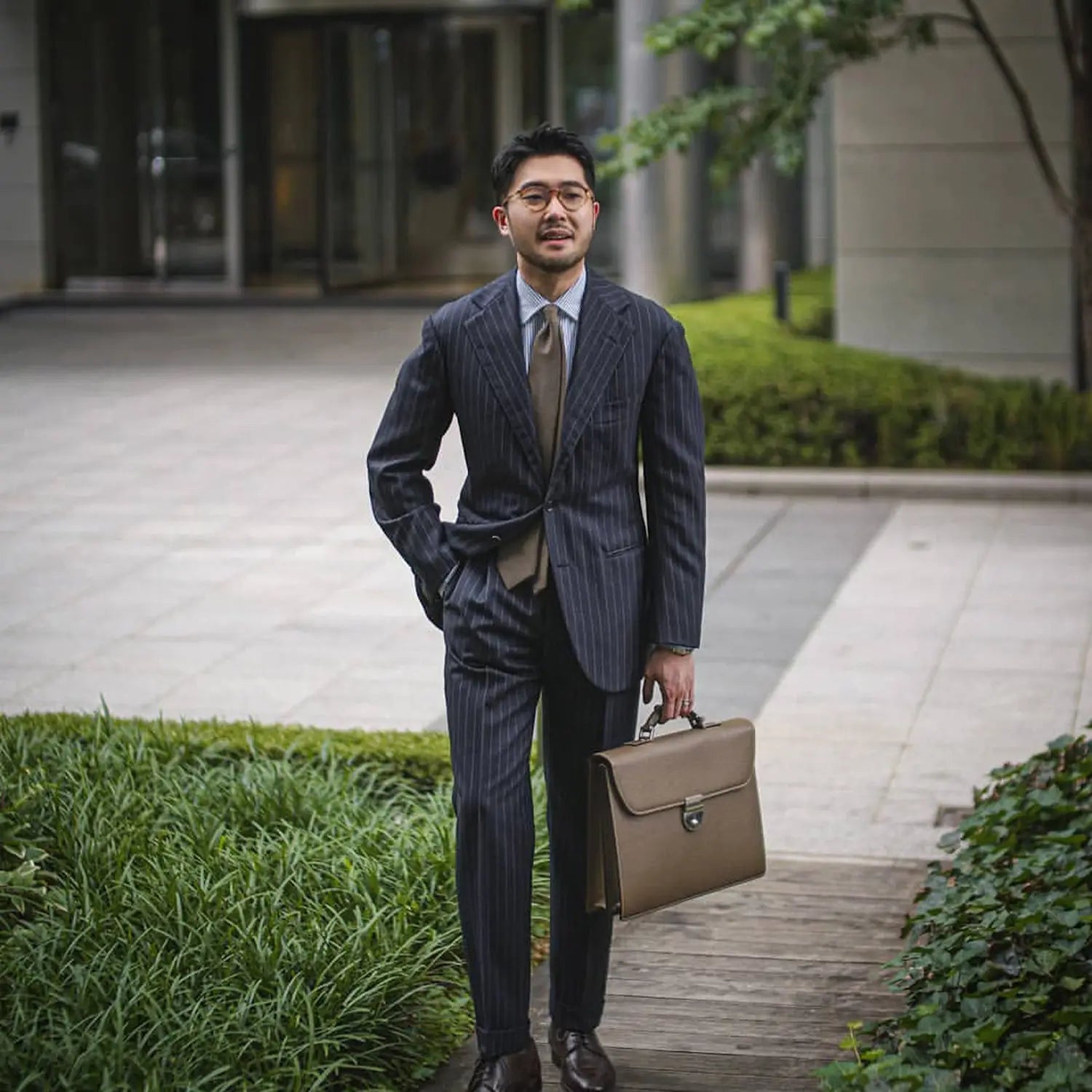 Striped suit with briefcase illustrating professional attire for extra mile and open collars