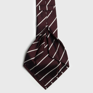 Close-up of the white striped deep burgundy six-fold tie showing its intricate folding.