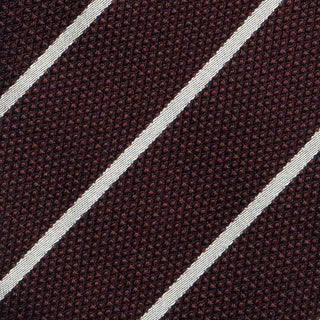 Detailed texture of white striped deep burgundy six-fold tie highlighting its silk material.