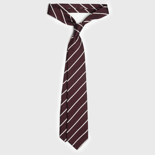 White striped deep burgundy six-fold tie tied in a classic knot on a white background.