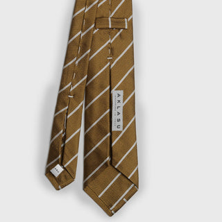 Back view of white striped metallic gold silk tie with brand label.