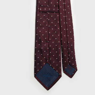 Back view of burgundy silk tie showing detailed stitching and label.