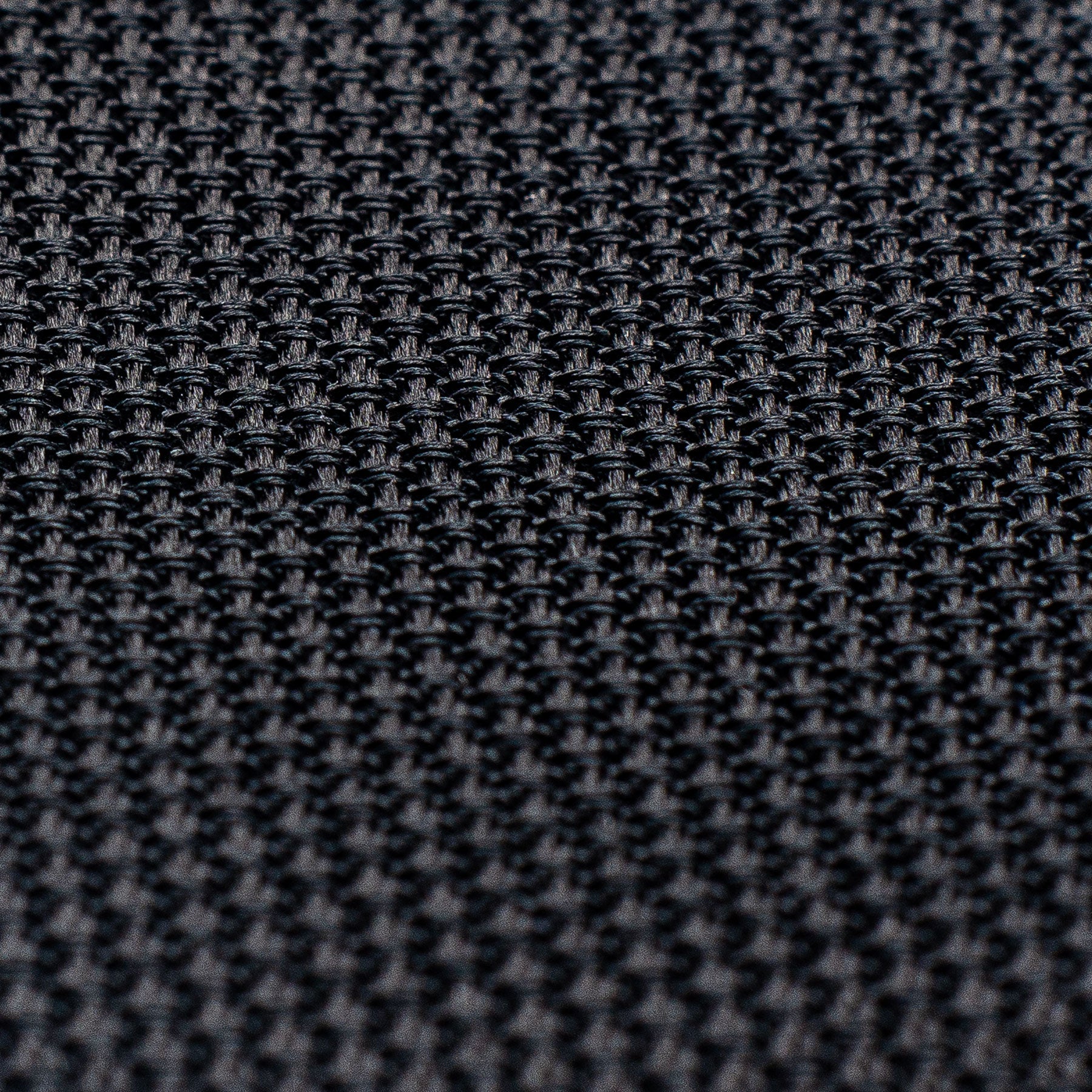 Detailed texture of black grenadine tie, emphasizing its intricate weave.