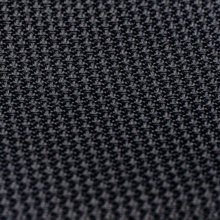 Detailed texture of black grenadine tie, emphasizing its intricate weave.