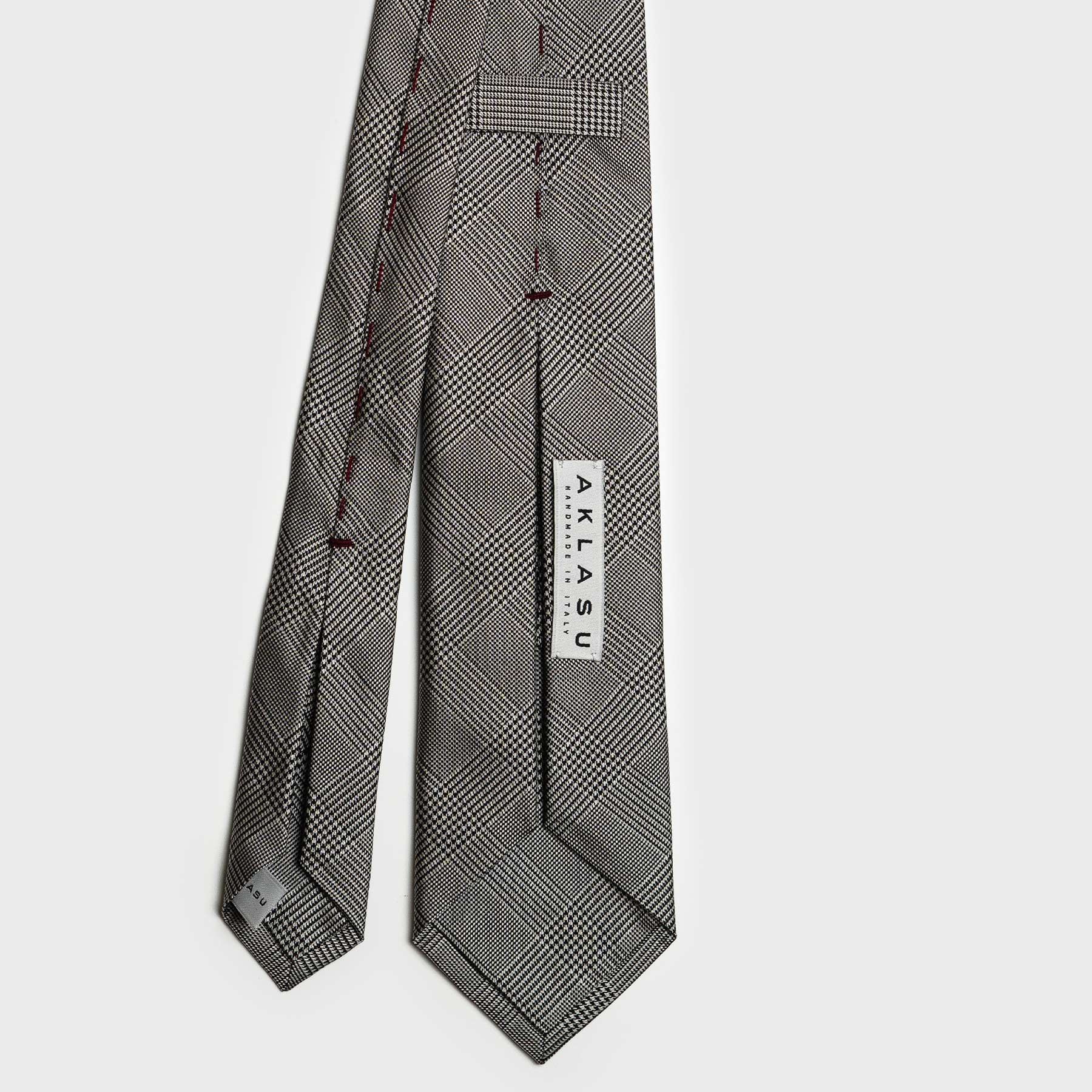 Back view of Glen plaid tie with detailed stitching and brand label.