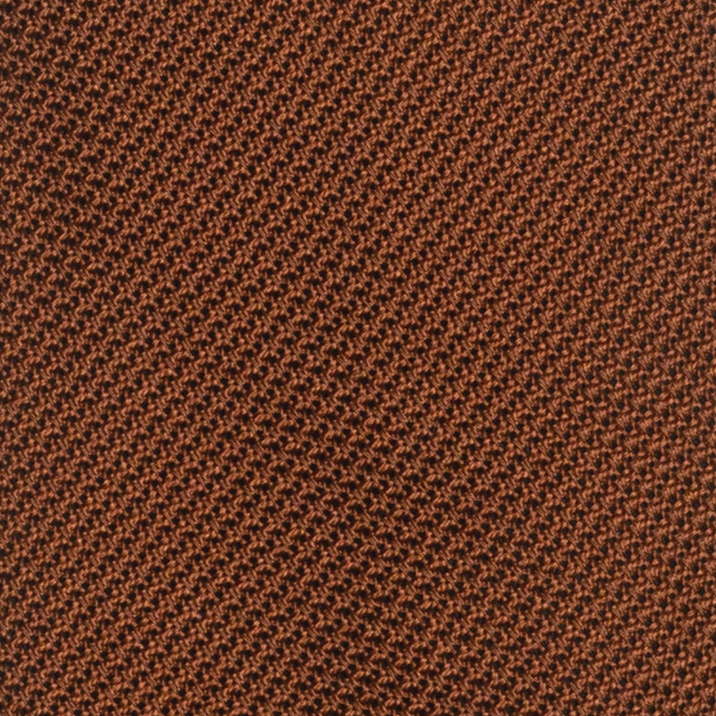 Close-up of burnt orange grenadine tie's intricate textured weave.
