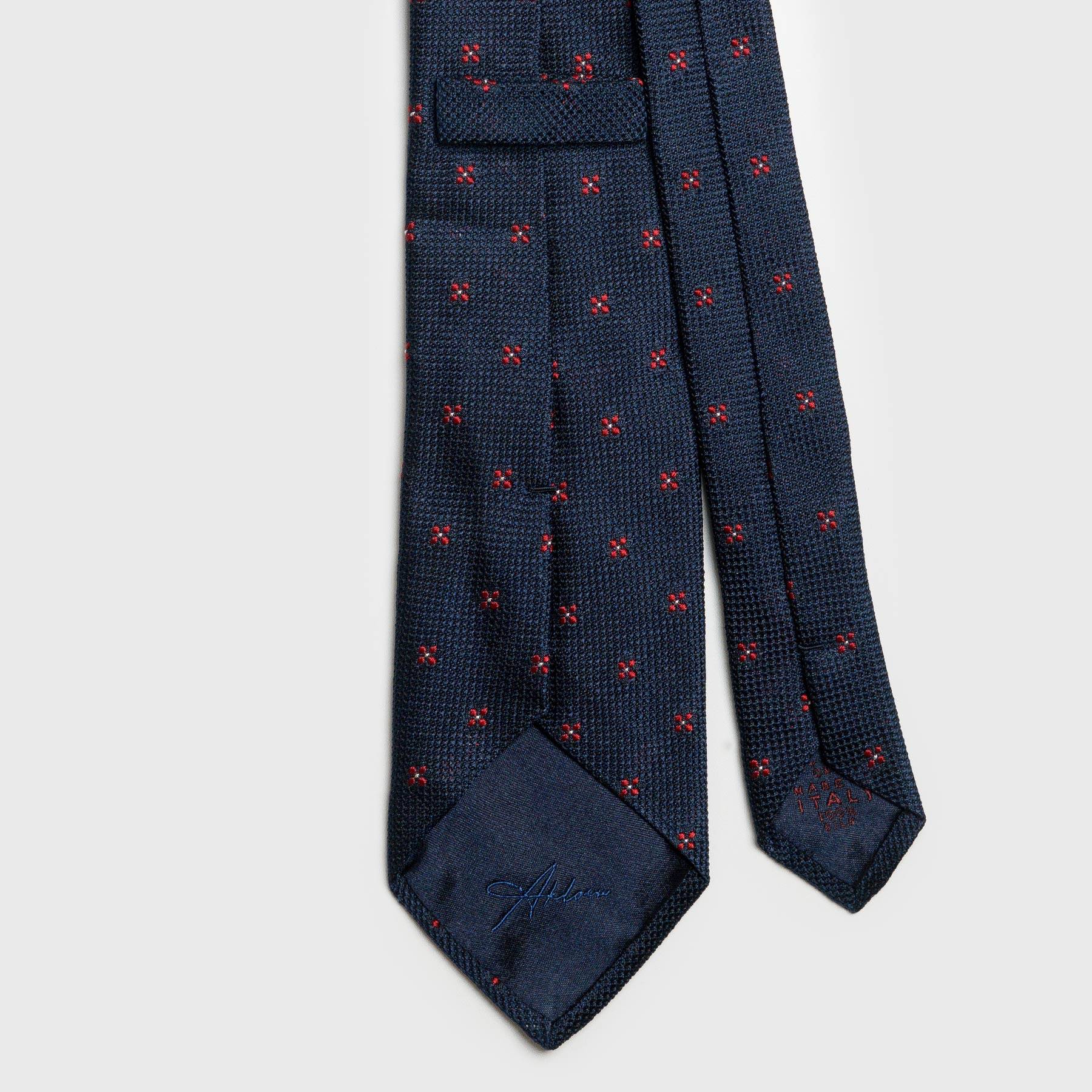 Back view of dark blue floral grenadine tie showing intricate stitching.