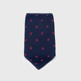 Dark blue floral grenadine tie with red flower pattern, folded neatly.