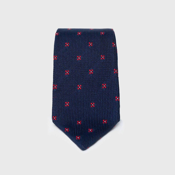 Dark blue floral grenadine tie with red flower pattern, folded neatly.