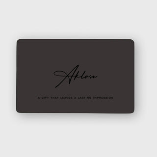 Aklasu Gift Card in sleek black design with elegant script logo and tagline 'A gift that leaves a lasting impression'. Ideal for timeless style gifts.