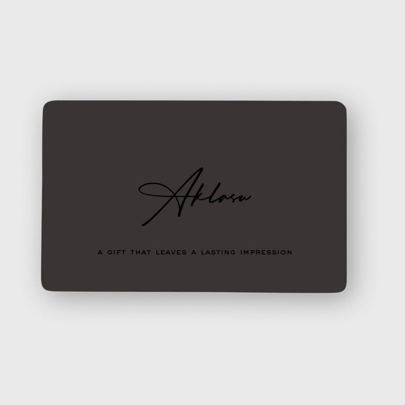 Aklasu Gift Card in sleek black design with elegant script logo and tagline 'A gift that leaves a lasting impression'. Ideal for timeless style gifts.