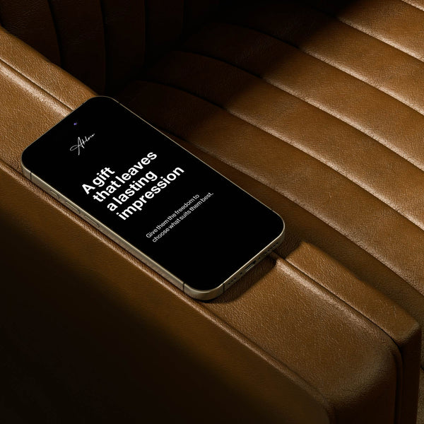 Aklasu Gift Card – Timeless Style for Every Impression displayed on a smartphone resting on a brown leather seat, ideal for gifting elegant accessories.