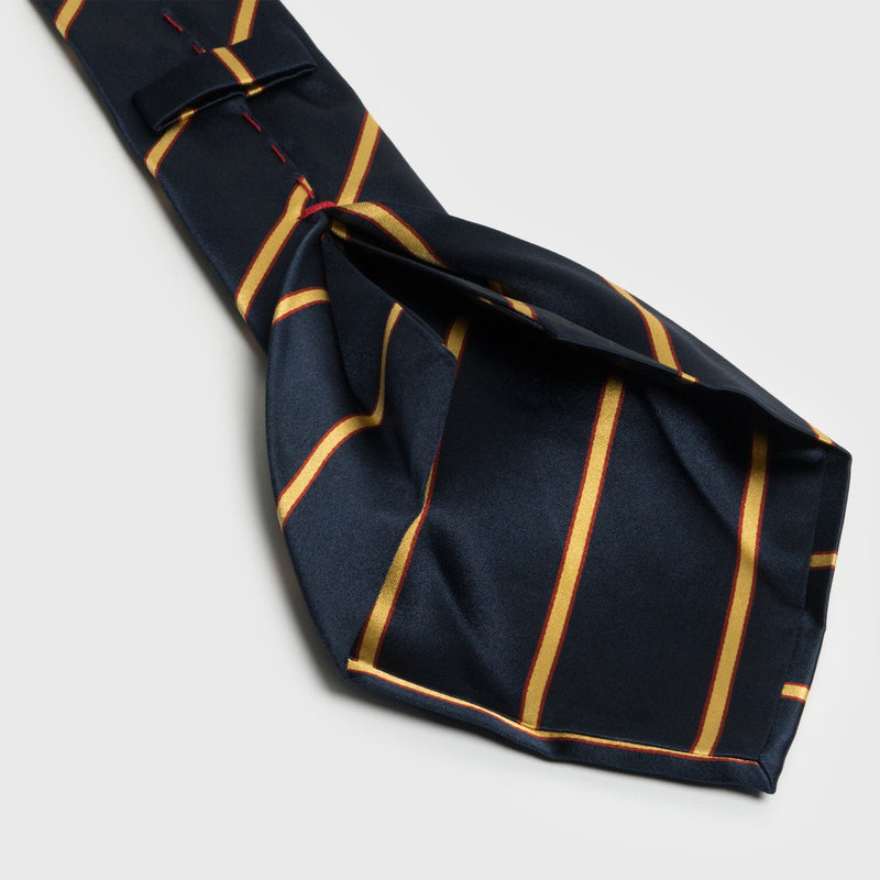 Back view of gold and red striped navy blue tie, revealing its intricate six-fold construction.