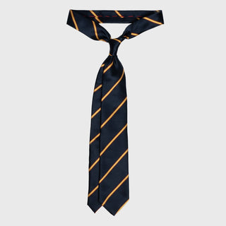 Gold and red striped navy blue tie tied in a classic knot, highlighting its six-fold craftsmanship.