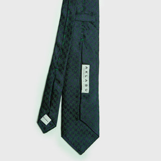 Green and navy blue houndstooth six-fold silk tie, handcrafted in Italy, ideal for formal attire.