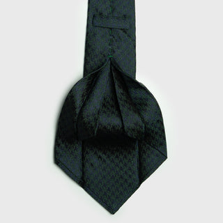 Green and navy blue houndstooth six-fold silk tie, handcrafted in Italy, showcasing luxury and sophistication.