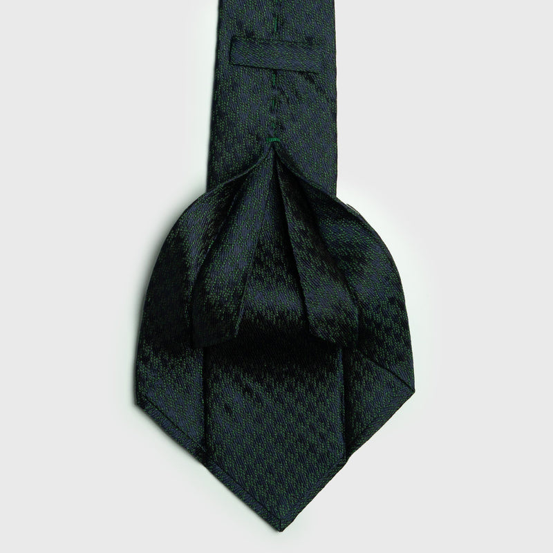 Green and navy blue houndstooth six-fold silk tie, handcrafted in Italy, showcasing luxury and sophistication.