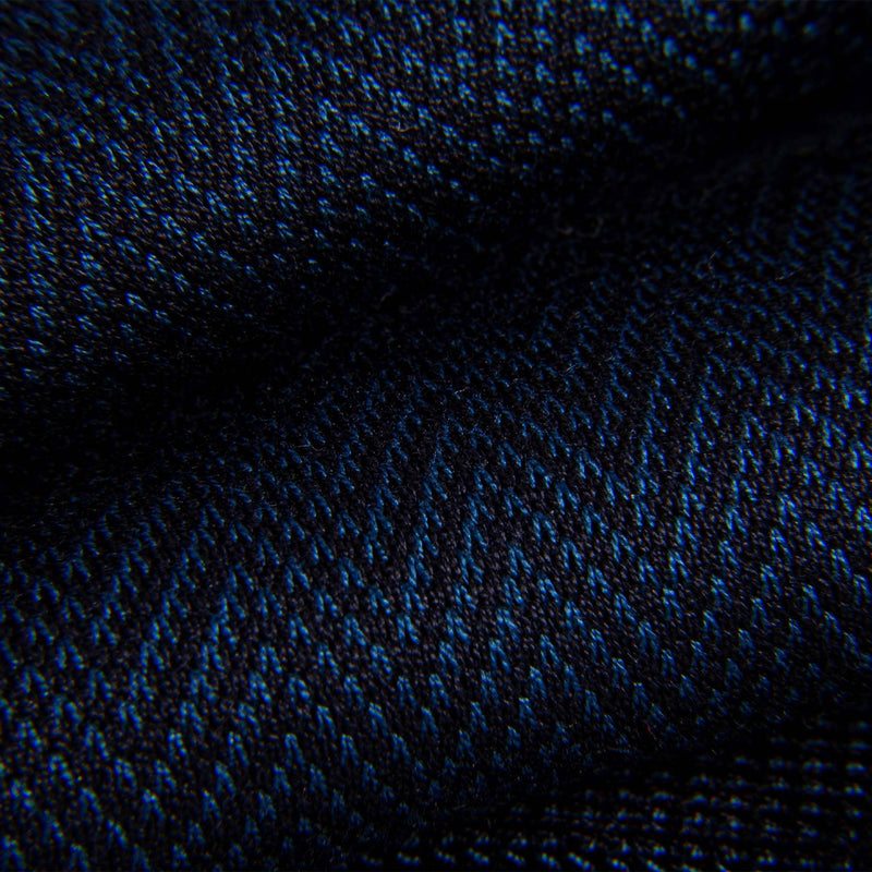 Close-up of blue and black chevron pattern on dress sock fabric.