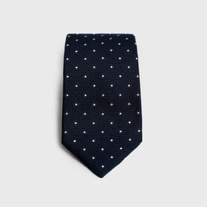 Navy dotted grenadine tie with a textured finish, folded for display.