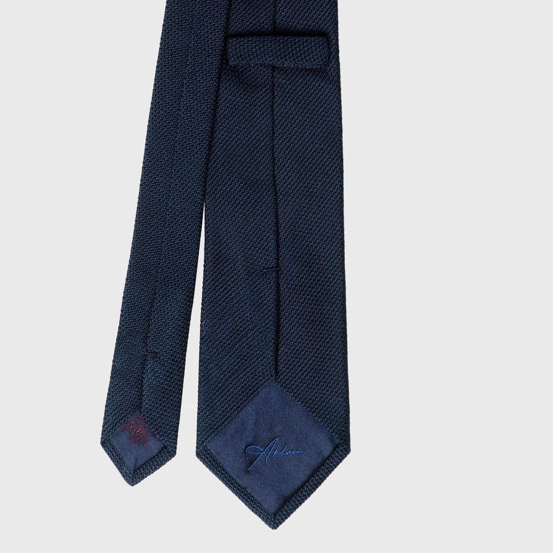Back view of Navy Grenadine Tie with detailed stitching and label. Classic Navy Tie for Men.