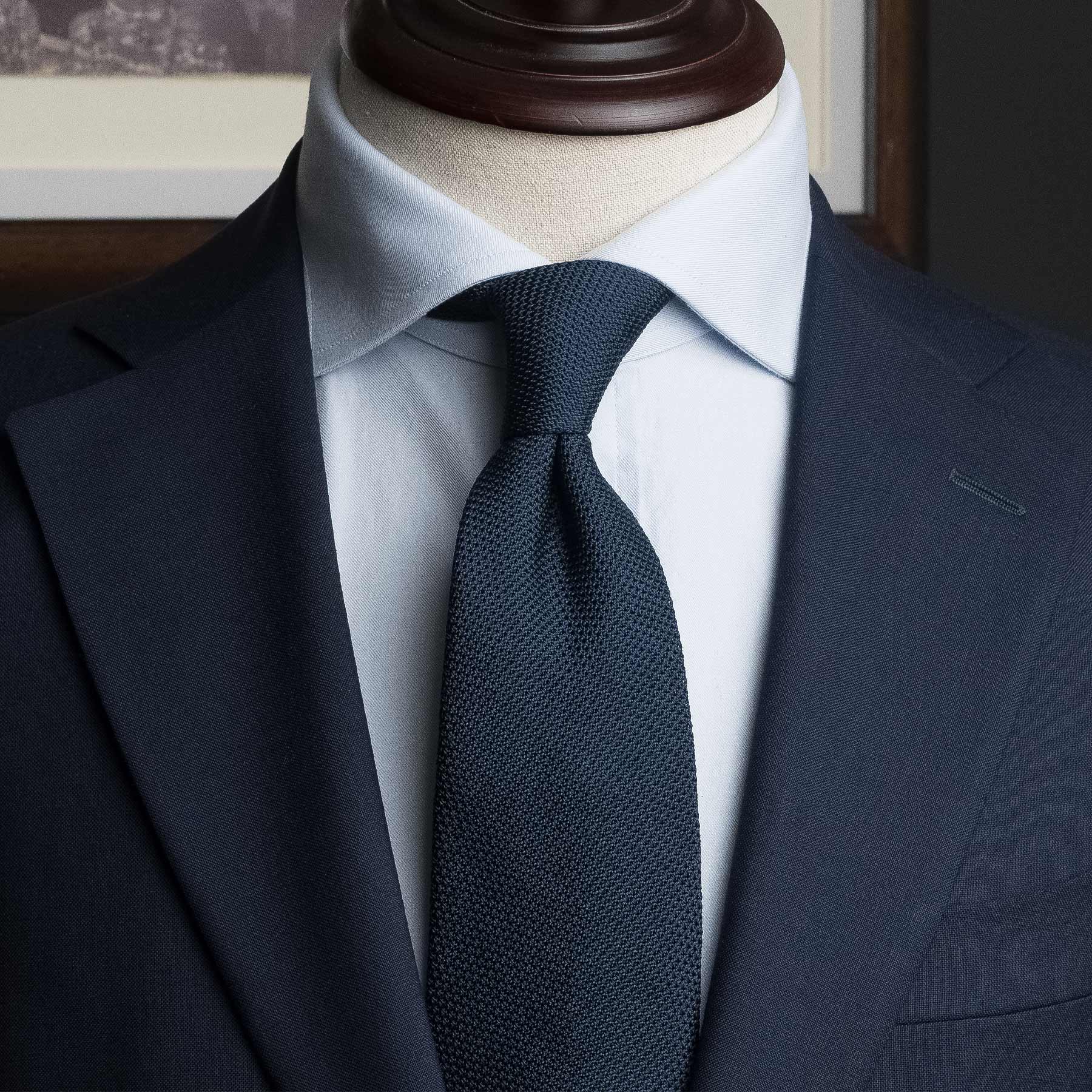 Navy Grenadine Tie styled with a suit, highlighting its refined look. Classic Navy Tie for Men.