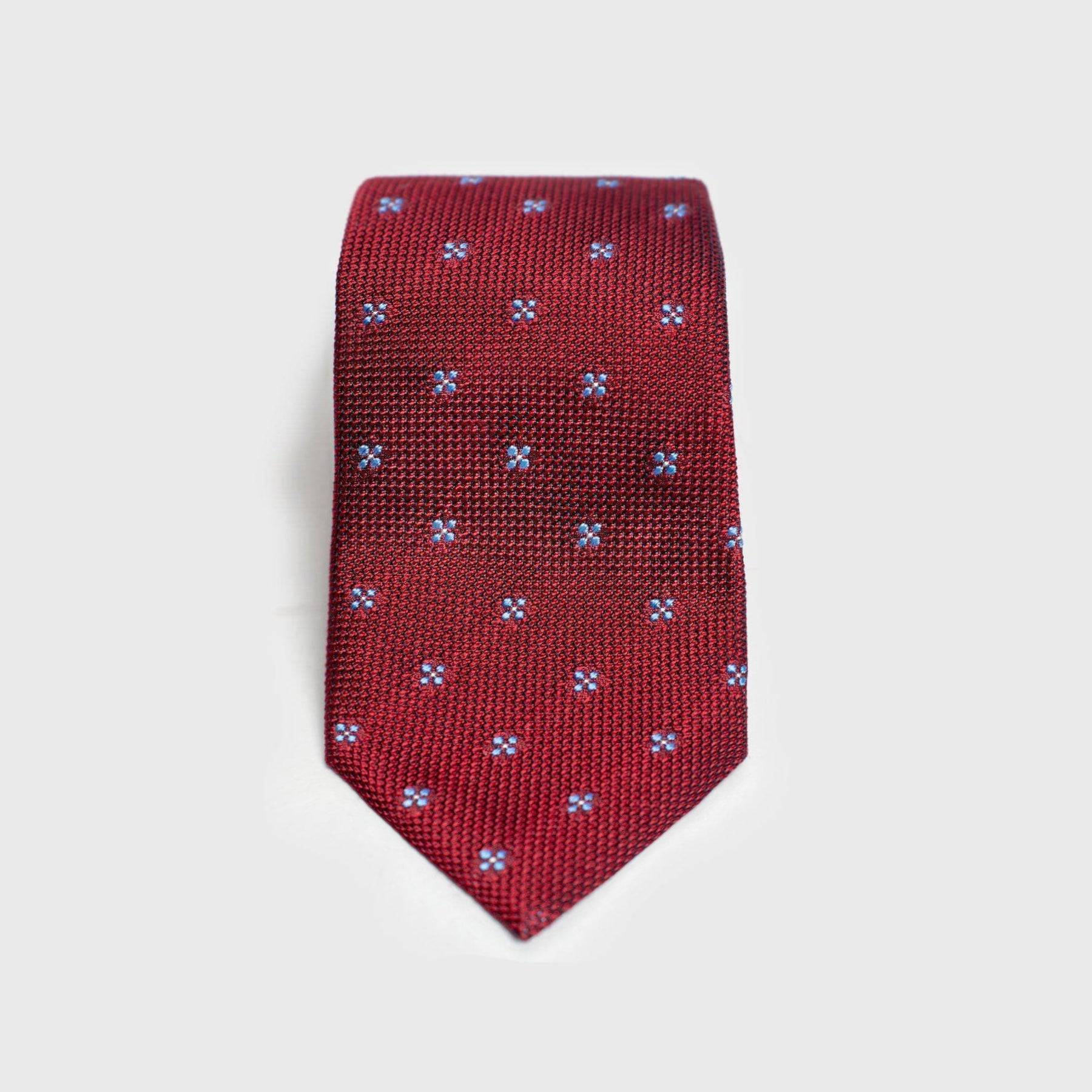 Red floral grenadine tie with blue floral design, handmade from 100% silk.