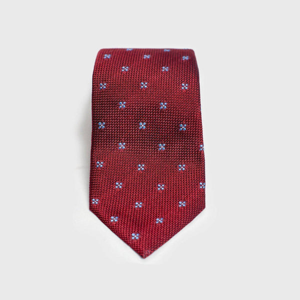 Red floral grenadine tie with blue floral design, handmade from 100% silk.
