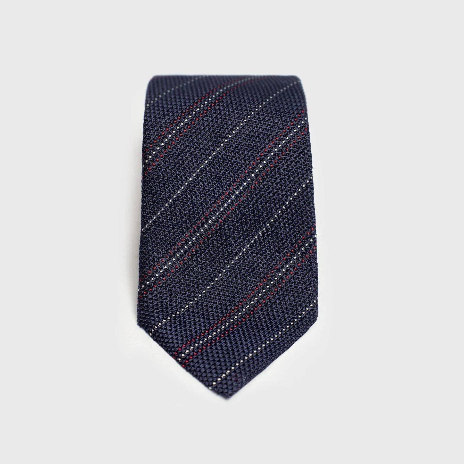 Red and white striped blue grenadine tie displayed flat.