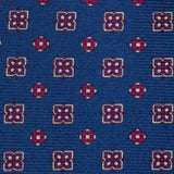 Close-up of royal blue silk tie showcasing intricate floral foulard print.