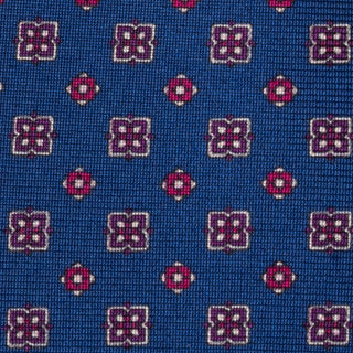 Close-up of royal blue silk tie showcasing intricate floral foulard print.