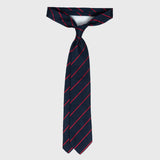 Full view of smooth red striped blue grenadine tie, untied and displayed.