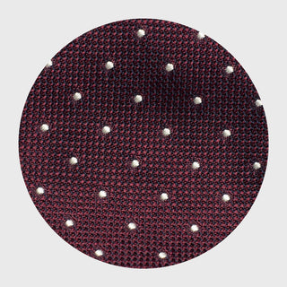 Close-up of textured grenadine silk fabric with white dotted design.