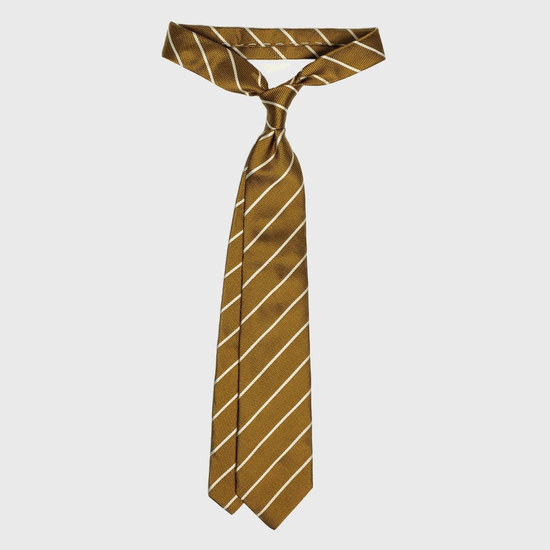 Full-length white striped metallic gold silk tie, knotted.