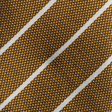 Detailed texture of white striped metallic gold silk tie fabric.