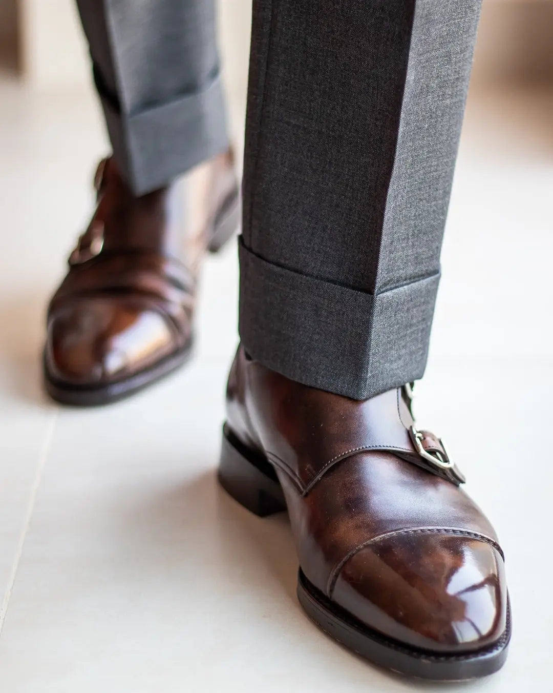 Brown leather double monk strap shoes showcasing small details for a systems check warning sign