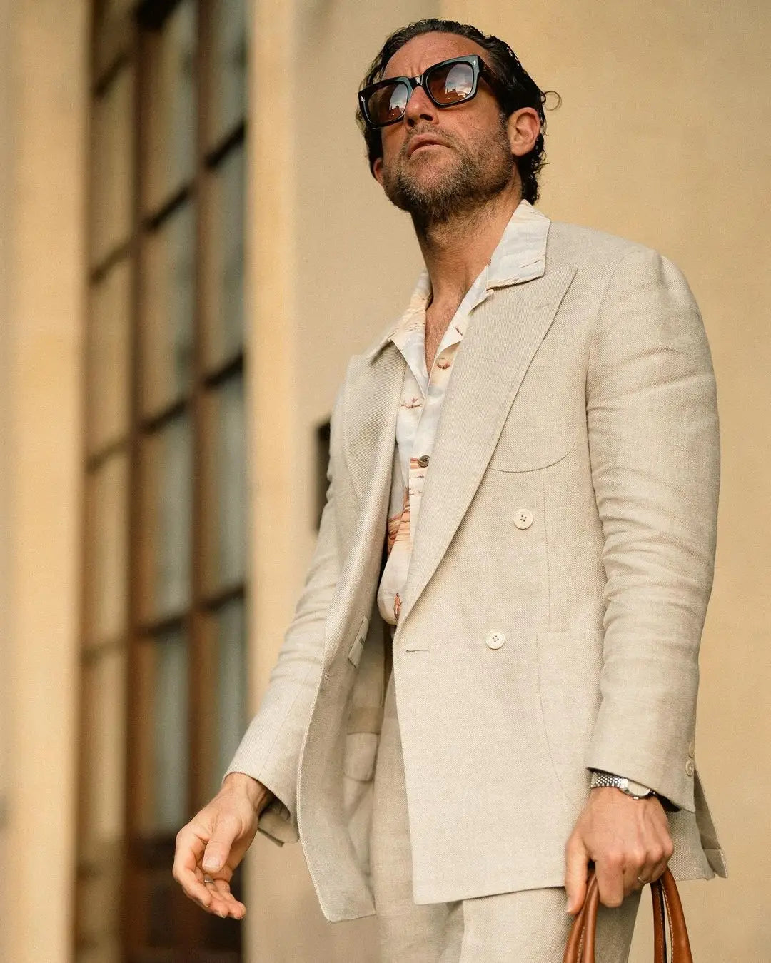 Man in a double-breasted suit and sunglasses showcasing polished men’s vacation style