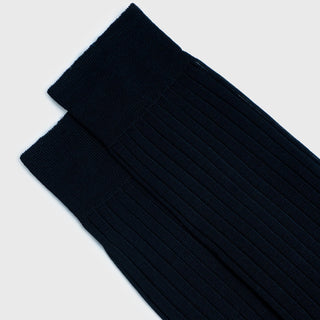 Pair of dark blue dress socks showing ribbed cuffs and texture.