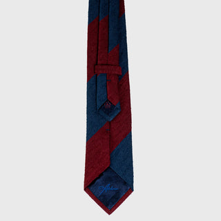 Back view of navy blue and burgundy striped shantung tie with signature detailing.