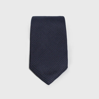 Micro patterned navy blue silk tie with a sleek and elegant design.