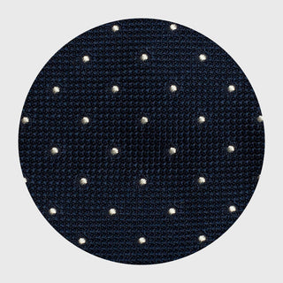 Close-up of navy dotted grenadine fabric, highlighting its texture and dots.